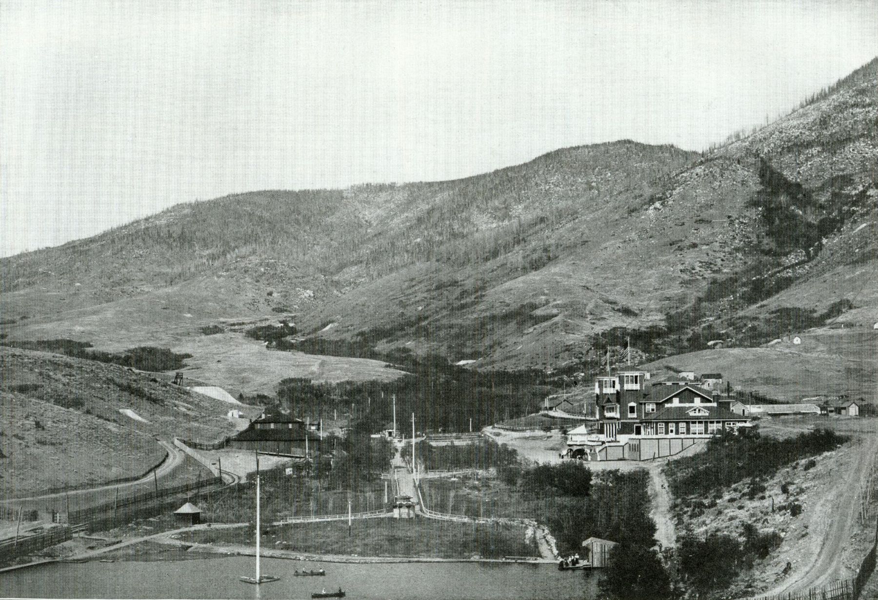 Columbia Gardens amusement park in Butte around 1900, pavilion and lawns below bare mountain slopes